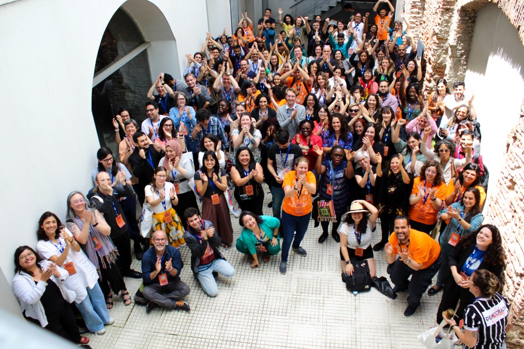 Group photo with dozens of people clapping